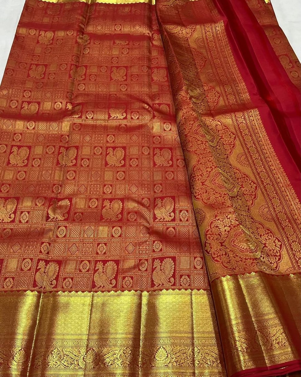 Uma – Vermilion Red Banarasi Soft Silk Saree with Peacock Zari Checks & Grand Floral Pallu